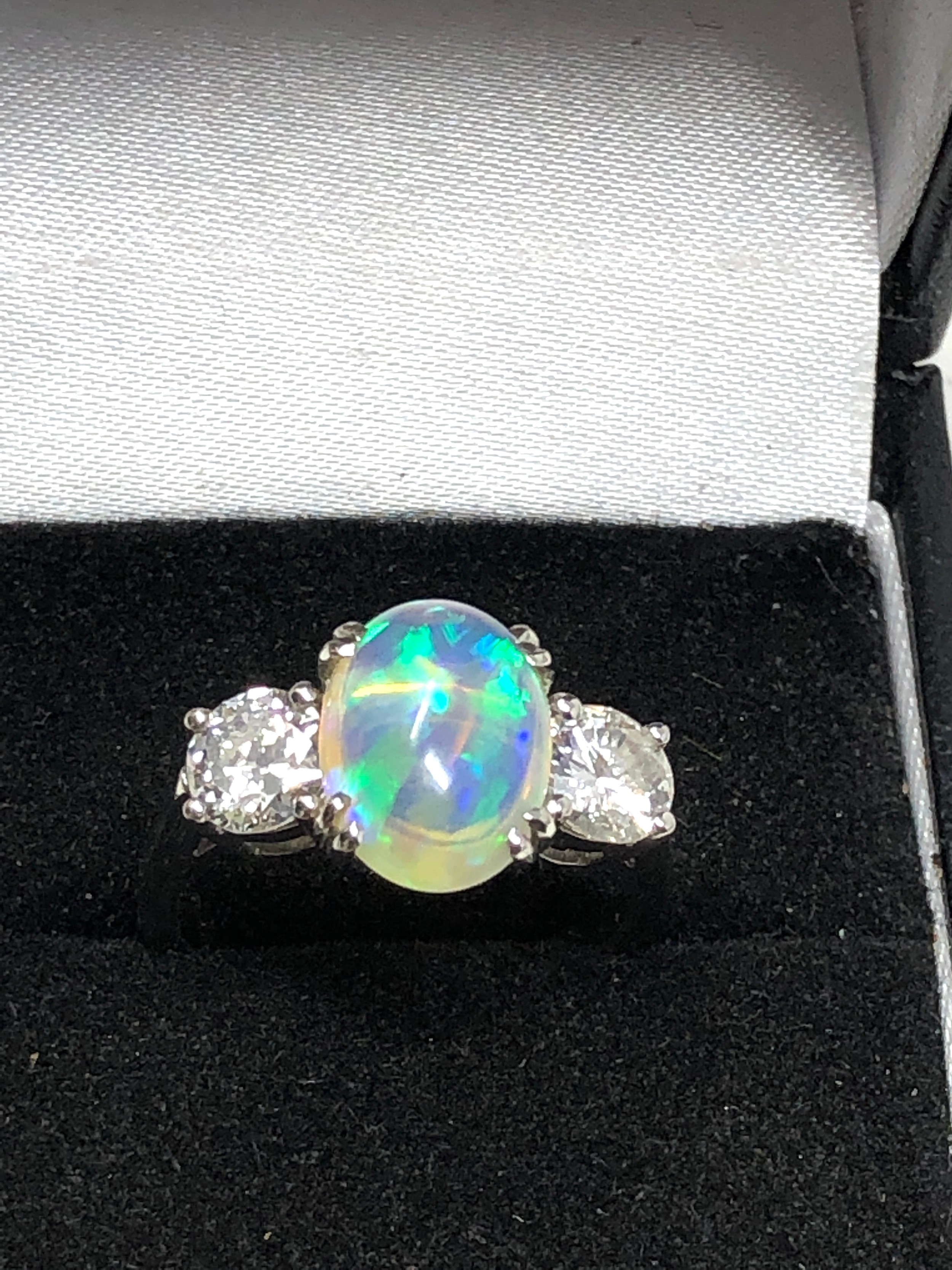 Fine plat opal & diamond ring set with centralop[al that measures approx 11.5mm by 8mm with