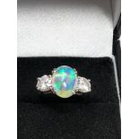 Fine plat opal & diamond ring set with centralop[al that measures approx 11.5mm by 8mm with