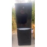 Black Indesit fridge freezer, working order, approximate measurements: Height 69 inches, Width 23