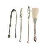 Early pair of sterling silver sugar tongs and button hooks with silver handles and shoe horn