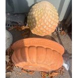 Terracotta wall planter and a terracotta acorn figure