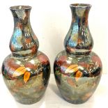 Pair Bistro Aztec ware vases, approximate height 12 inches, repair been made to the top