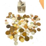 Selection of assorted coins and a vintage money box