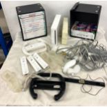 Nintendo Wii console and accessories to include remotes, remote covers, steering equipment and games