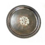 An Arts and Crafts hammered copper circular tray, by Hugh Wallis, inlaid with white metal 9 inches
