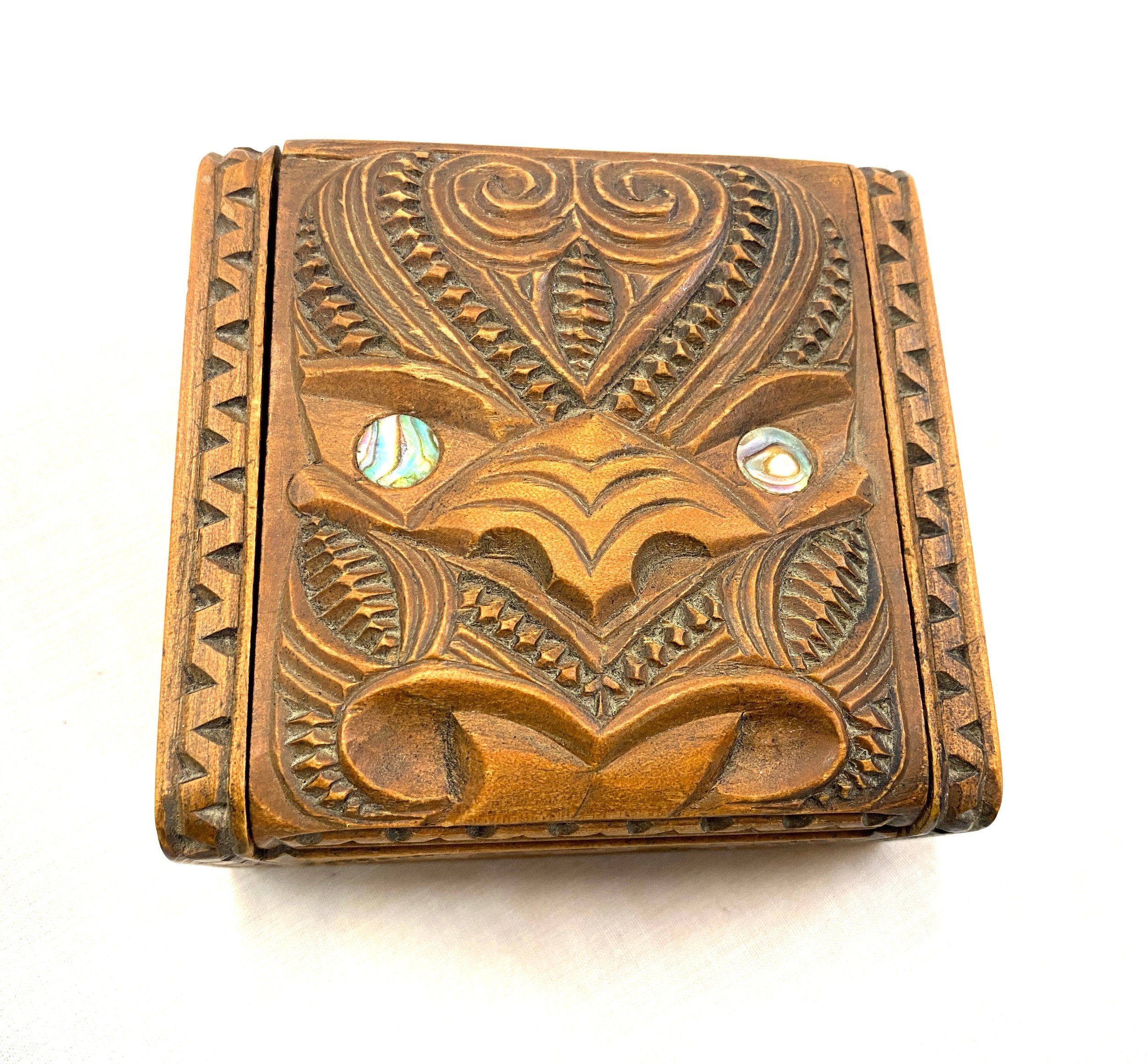 Carved New Zealand Maori box with Tiki lid and Paua shell eyes