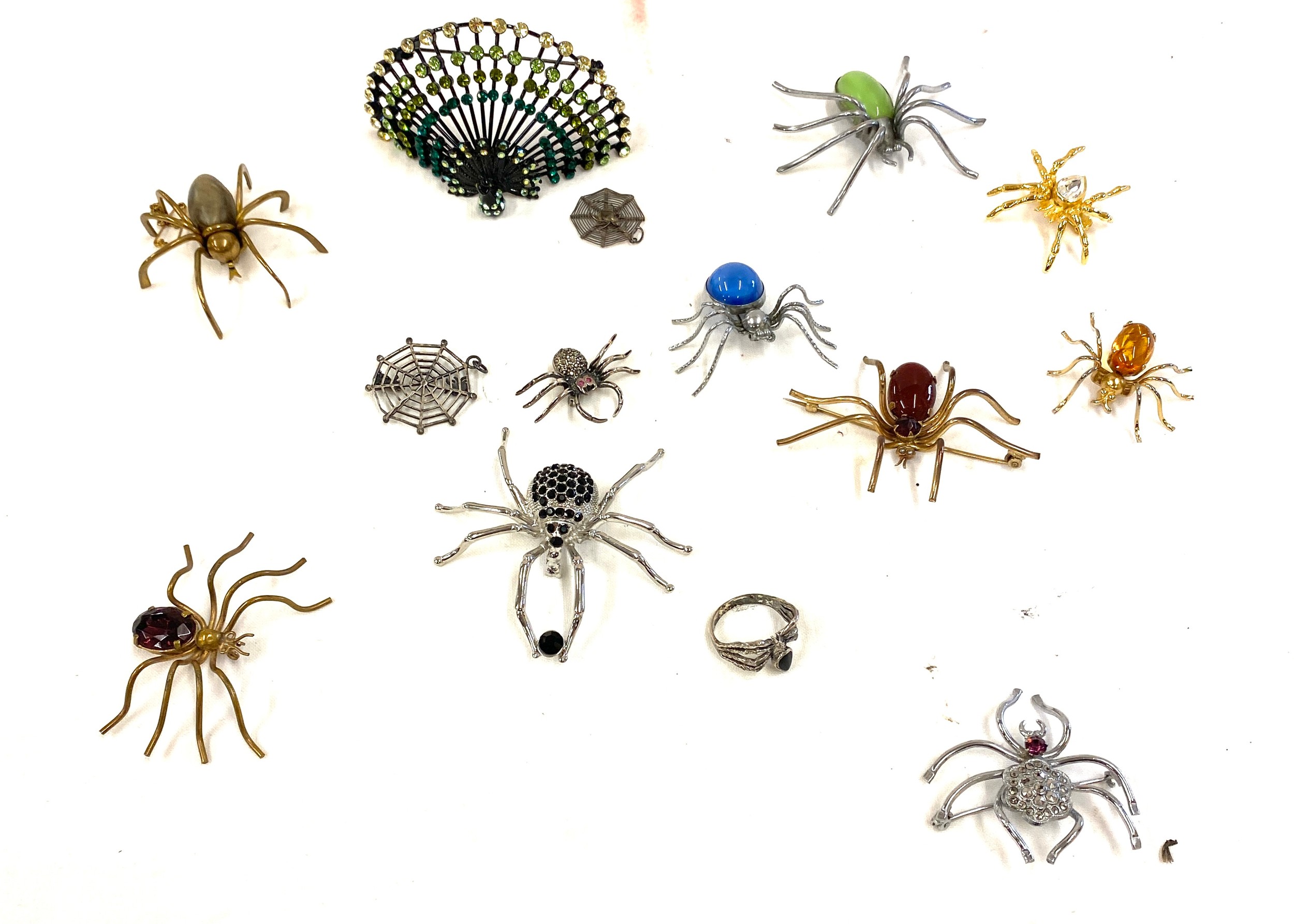 Selection of costume jewellery to include spider brooches etc