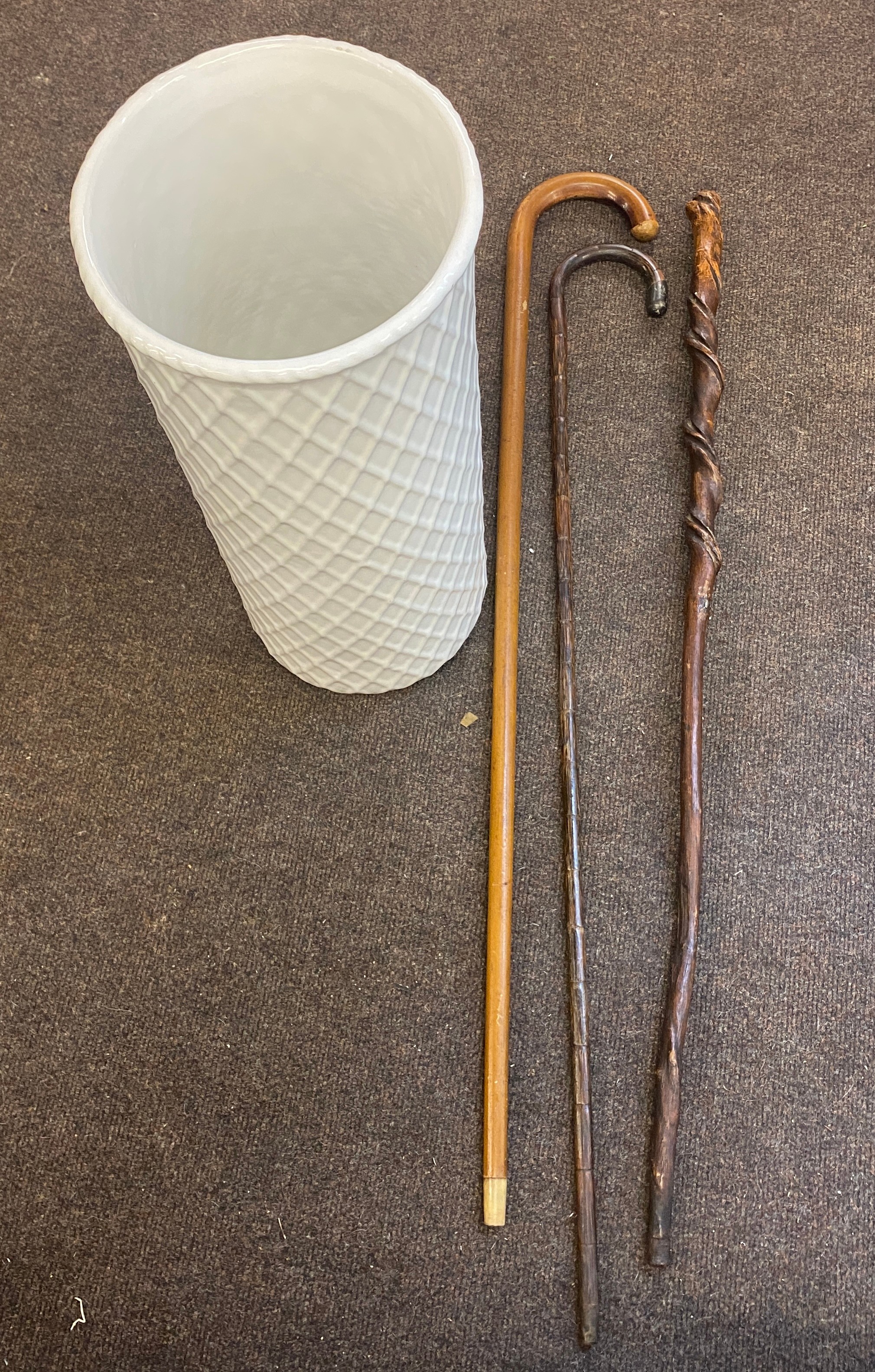 3 Vintage wooden walking sticks together with porcelain umbrella stand