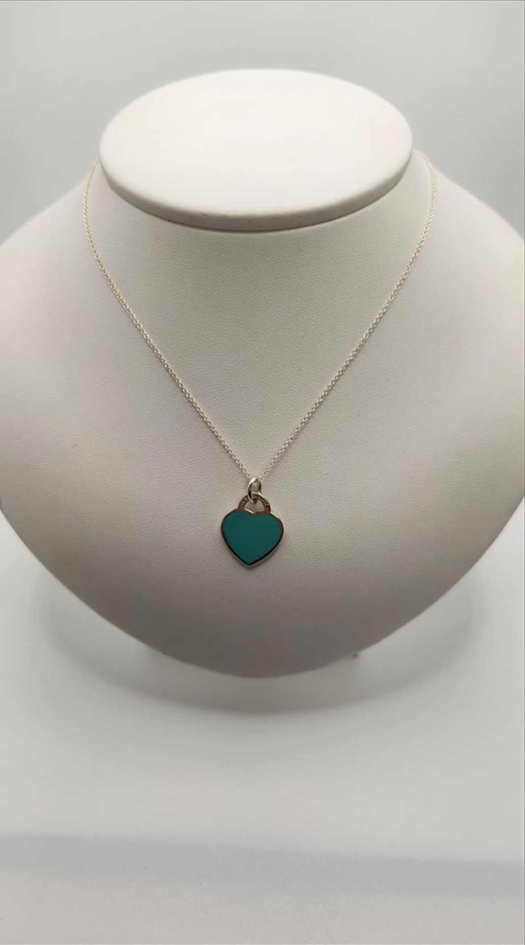 One lady’s stamped “Please Return to Tiffany and Co. new York 925” turquoise blue enamel heart