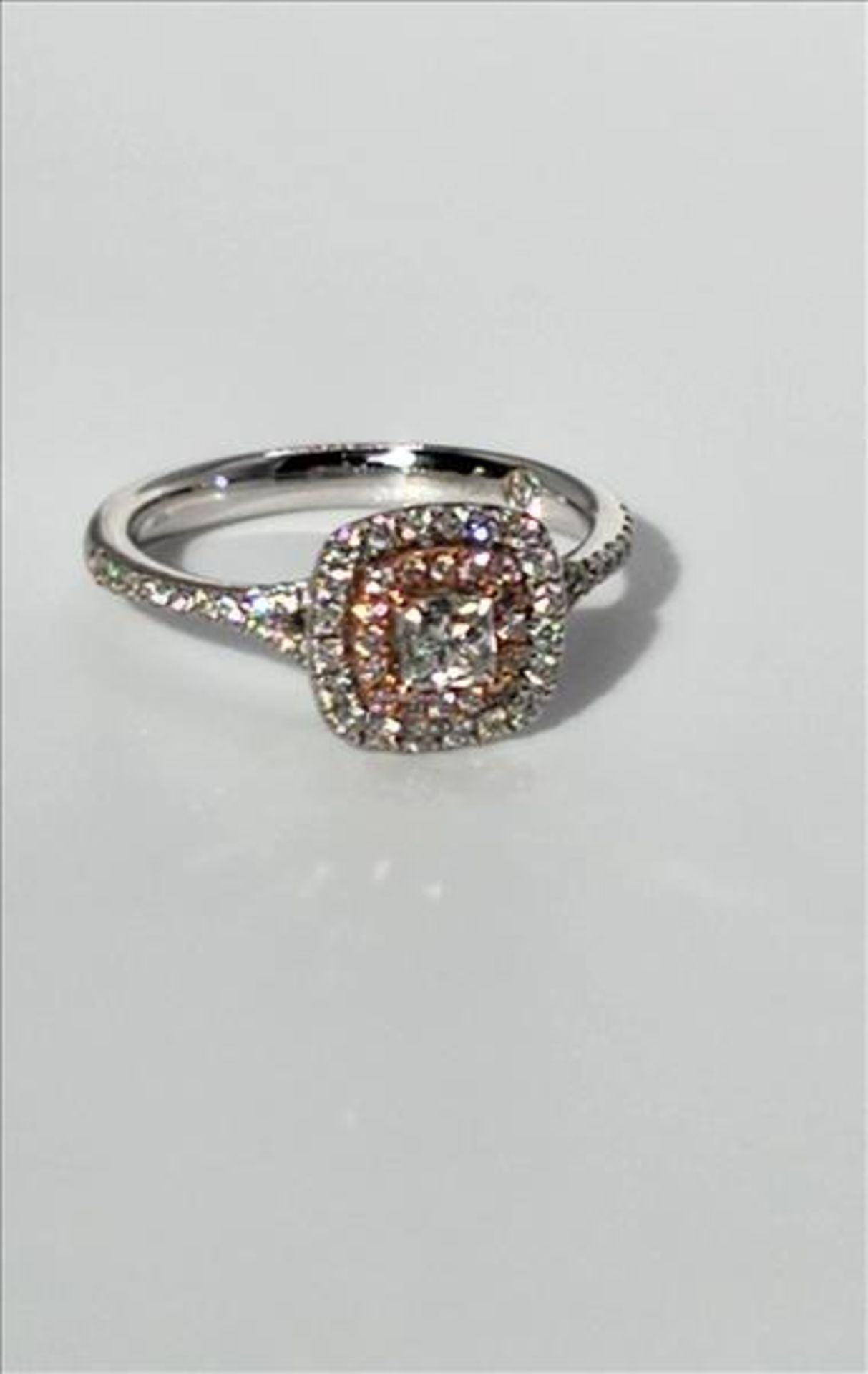 One lady’s stamped and tested 14kt white and pink gold diamond ring trademarked “Charmed” design