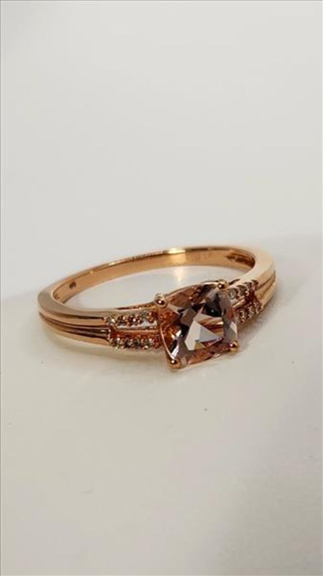 One lady’s stamped FDJ and tested 10kt pink gold Morganite and diamond ring. Contained at the centre