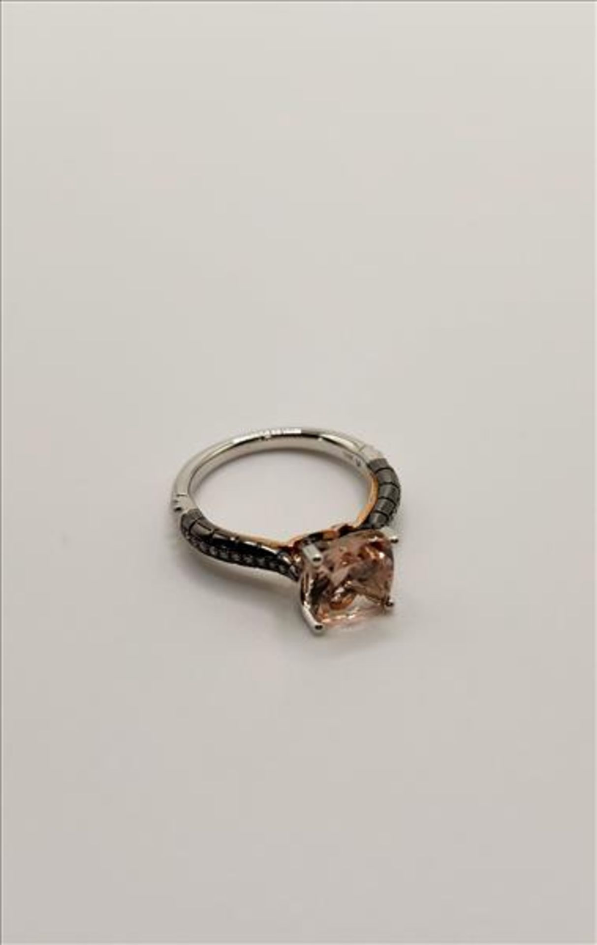 One lady’s stamped and tested 14kt white and pink gold Morganite, black and white diamond ring. Also