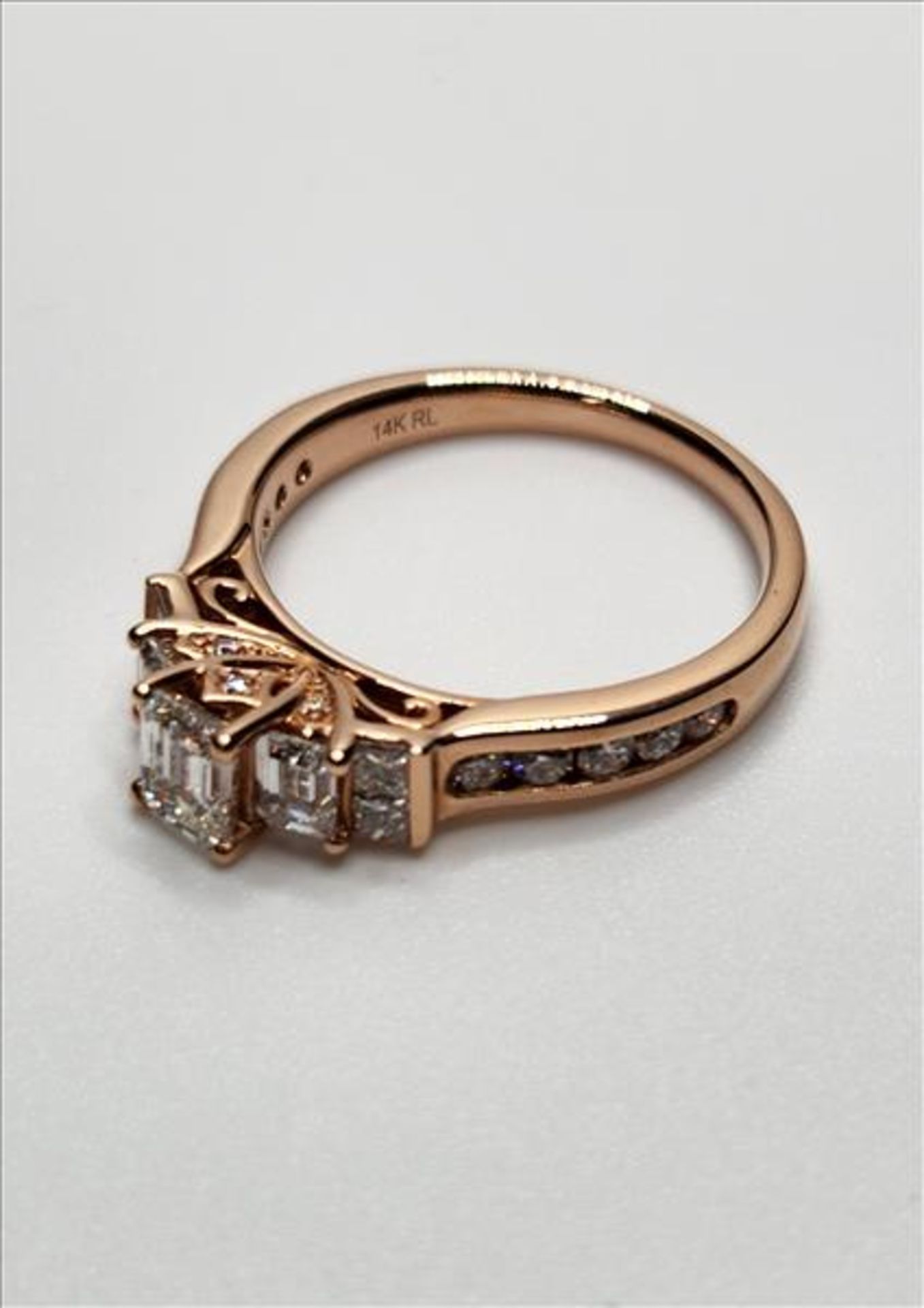 One lady’s stamped and tested 14kt (RL) pink gold diamond Past Present and Future engagement ring