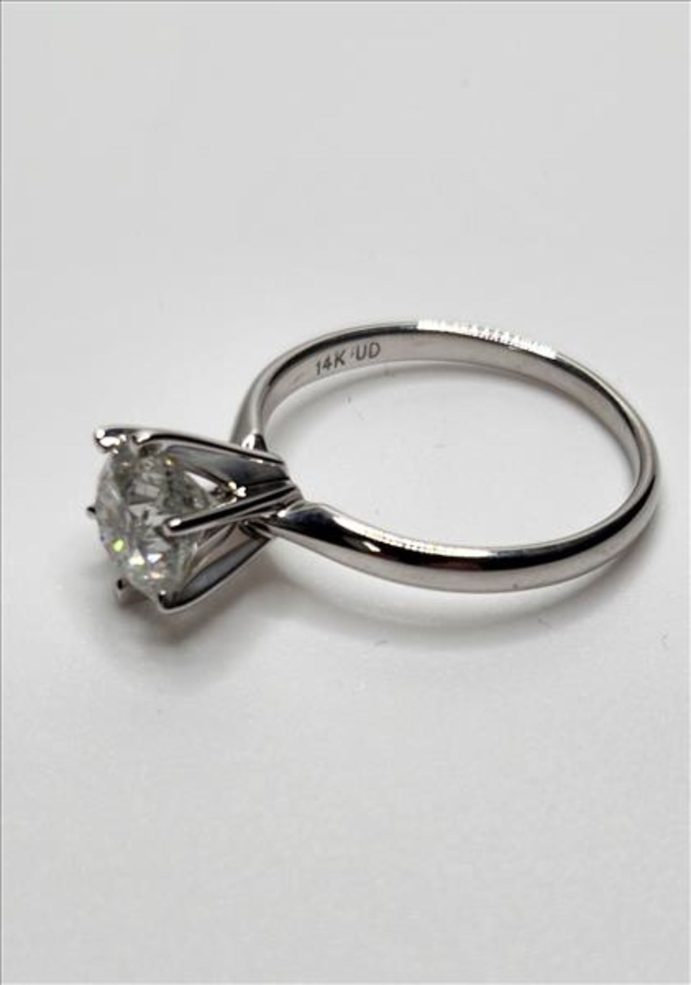 One lady’s stamped and tested 14kt white gold diamond solitaire engagement ring trademarked by Charm