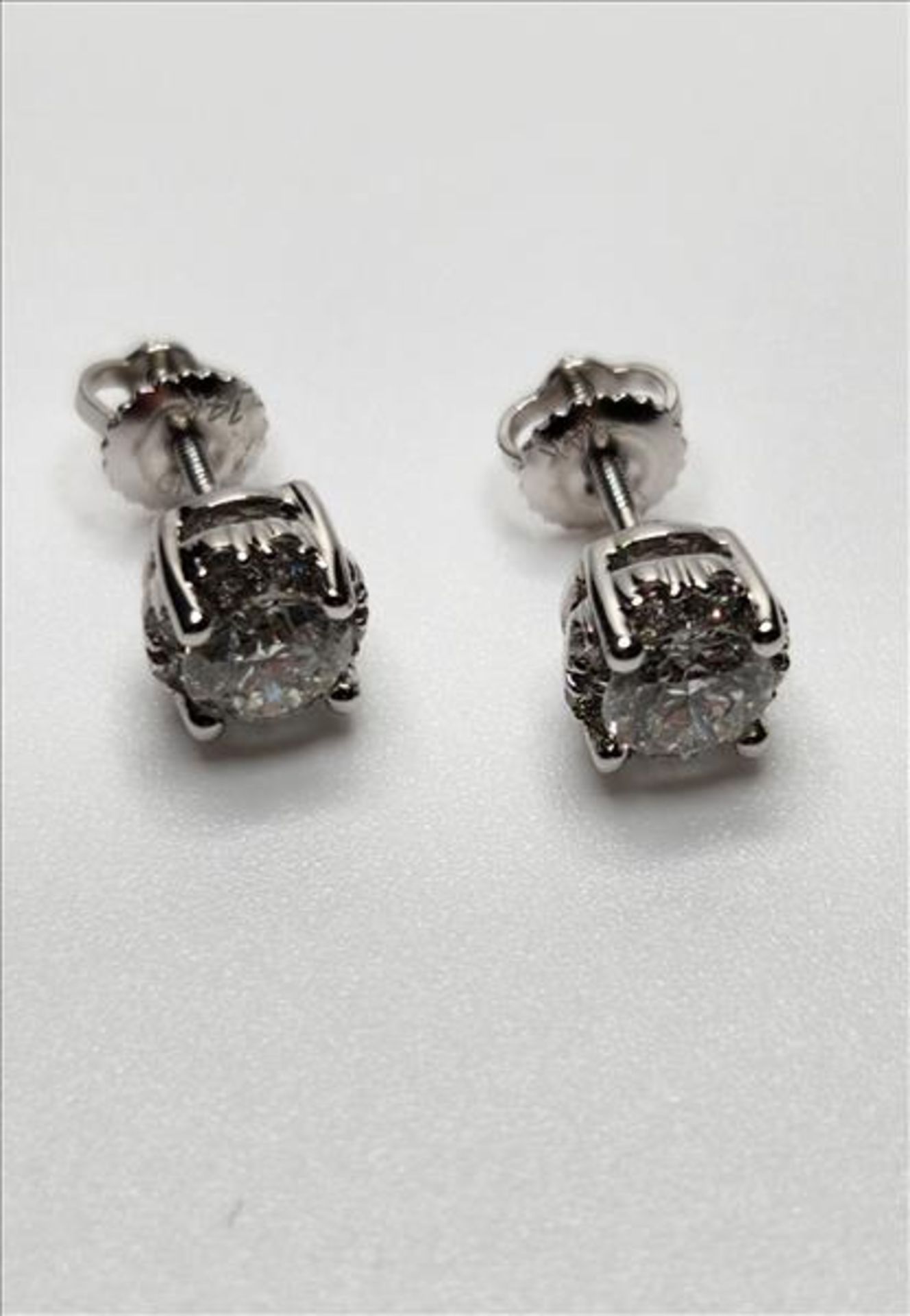 One pair of lady’s stamped and tested 14kt white gold Arctic Brilliance trademark Canadian Diamond