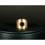 18-carat gold ring with a central sapphire