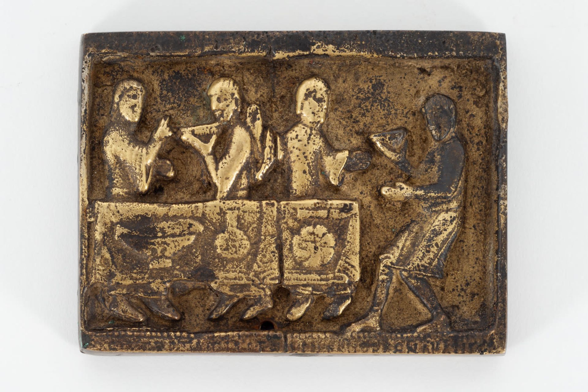 Romanesque bronze plaque representing a manners scene in relief, 13th century.