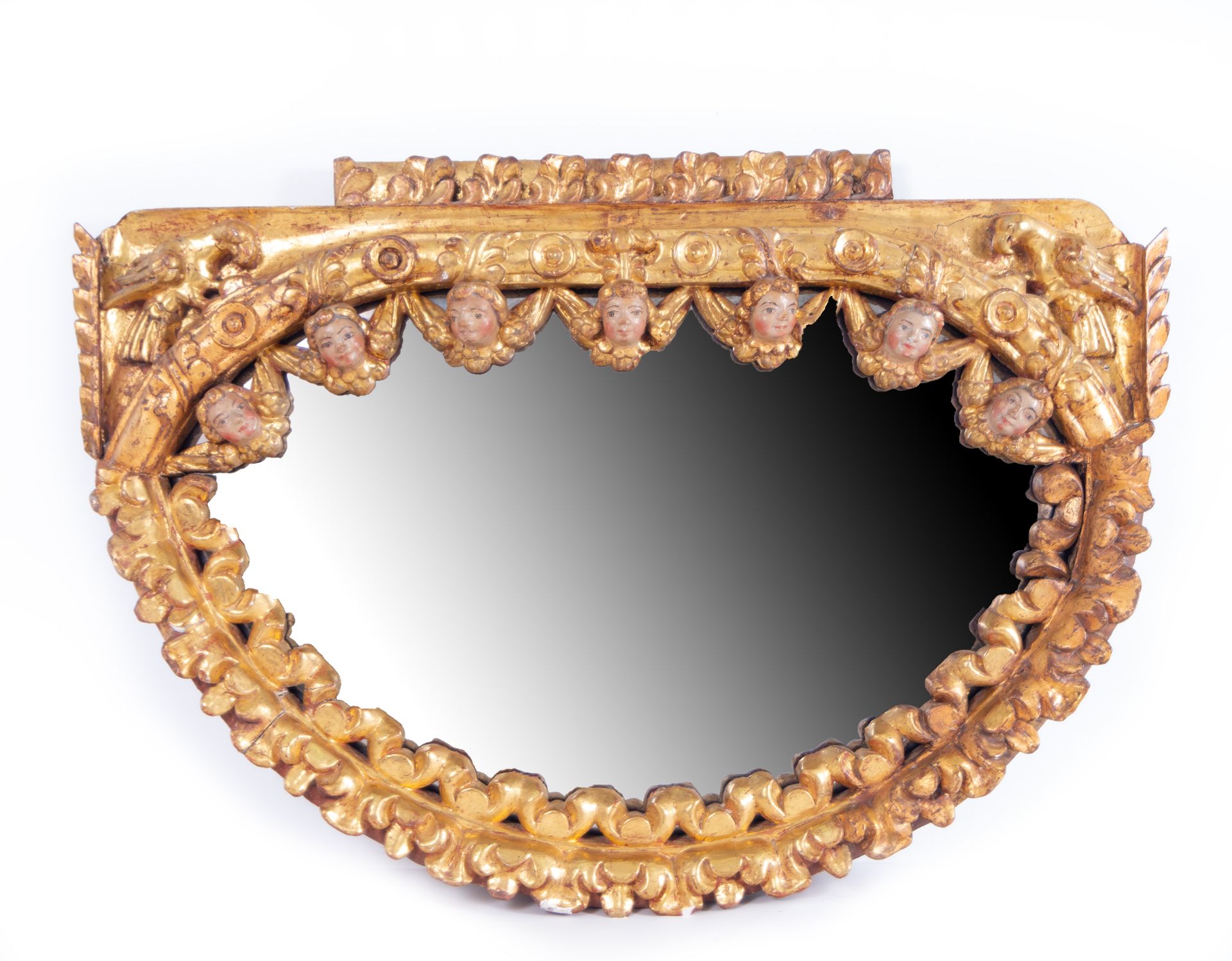 Rare Crescent-shaped Mirror in gilded wood tied with Angelote heads, colonial school of Cuzco, Peru,