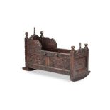 A Charles II carved oak cradle, initialled 'M H M' and dated 1667