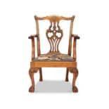 An early 20th century Chippendale style mahogany carved child's open armchair