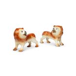 A large pair of 19th century Staffordshire glazed pottery lions with glass bead eyes