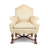 An early 20th century Carolean style walnut cream upholstered armchair