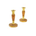 A pair of mid 19th century patinated bronze and ormolu candlesticks