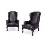 A pair of early 20th century George III style mahogany wing armchairs