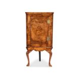 A George I and later burr walnut and mahogany banded corner cabinet on stand