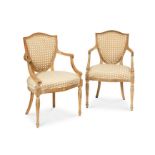 A pair of George III stripped beech wood carved open armchairs