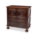 A Charles II oak four drawer chest