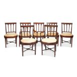 A set of seven George III mahogany dining chairs including a pair of open armchairs