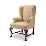 A George II style mahogany wing armchair