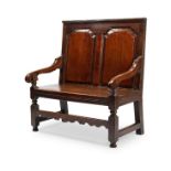 A small George III oak settle