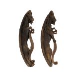 A pair of 18th century architectural carved oak lion corbels of scrolling form