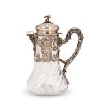 A late 19th century French rococo style silver and glass lemonade jug