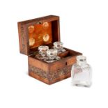 A Victorian Tunbridge ware box with geometric marquetry enclosing four small glass scent bottles