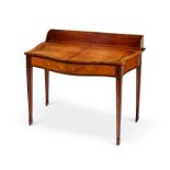 A George III satinwood marquetry serpentine gentleman's dressing table in the manner of John Cobb