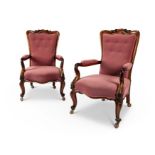 A pair early Victorian rosewood carved library armchairs