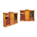 A pair of early Victorian Jacobethan style carved oak low cabinet bookcases