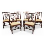 A set of six George III mahogany carved dining chairs
