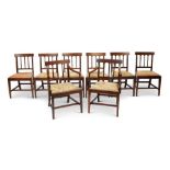 A set of eight late George III mahogany dining chairs, including a pair of open armchairs