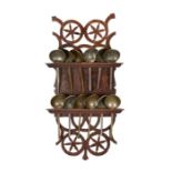 An 18th century oak spoon rack with twelve pewter spoons