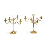 A large pair of Victorian articulated brass four-light candleabra