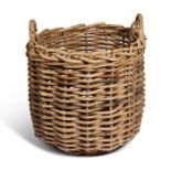 A large vintage wicker circular log basket