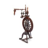 A 19th century elm, ash and bone turned upright treadle driven spinning wheel