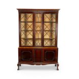 An early 20th century Chippendale style mahogany carved bookcase / cabinet