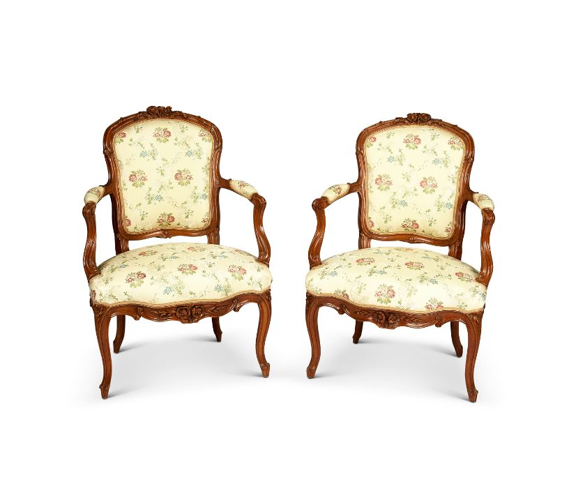 A pair of 19th century French Louis XV style walnut carved fauteuils / open armchairs