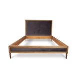 A contemporary limed oak kingsize bed frame with a padded headboard by Graham and Green
