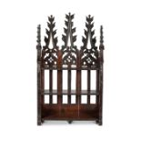 An unusual set of Victorian Gothic oak carved three-tier hanging shelves